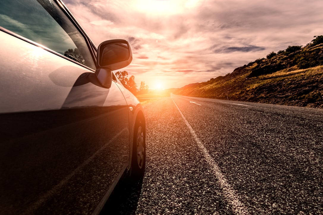 car-travelling-by-sunny-road