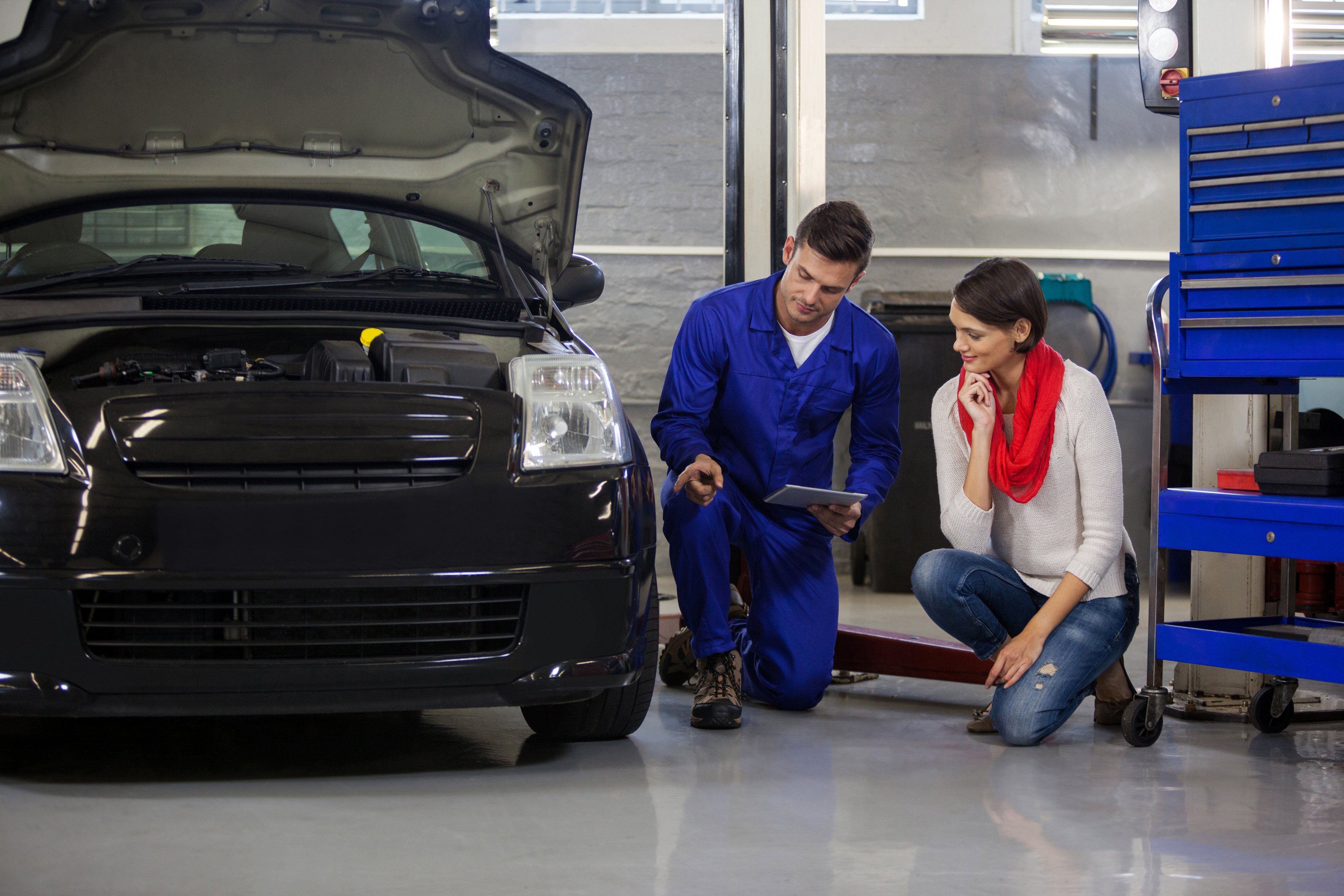 mechanic-showing-customer-problem-with-car